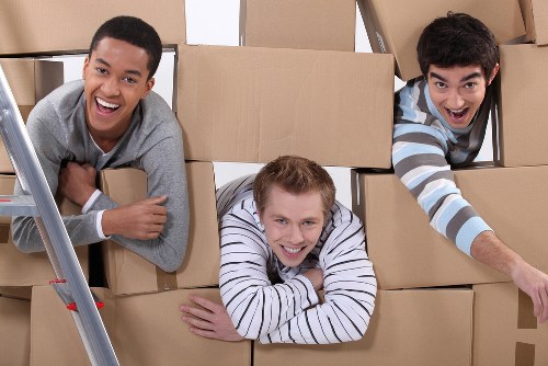 Professional movers handling furniture during an Acton house move