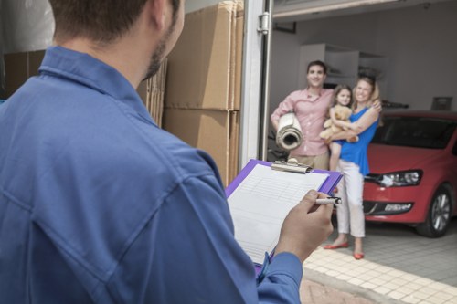 Packing boxes and preparing for flat removals in Acton