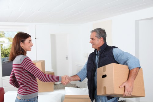 An organized Acton storage space with shelves and packed cartons