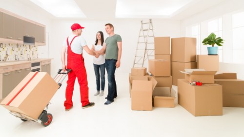 Office relocation team moving desks and equipment in Acton