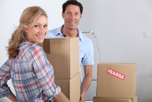 Professional movers handling furniture during local removals in Acton
